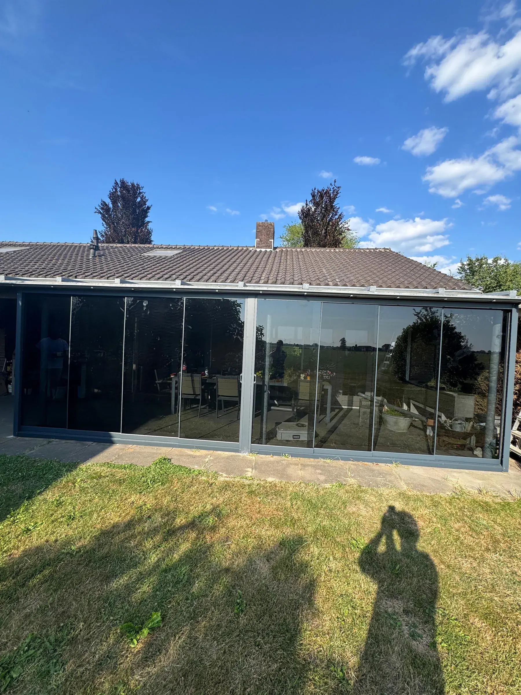 Glasschiebetür mit Blick auf eine ländliche Terrasse mit Esstisch